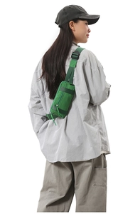 Detail of vibrant green nylon sports waist bag showing adjustable strap and buckle closure