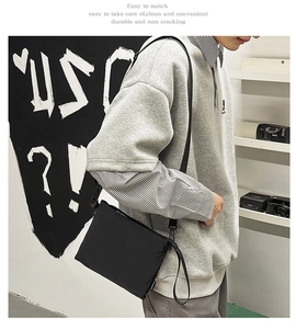 Detail of durable black nylon crossbody bag with adjustable strap in urban street style
