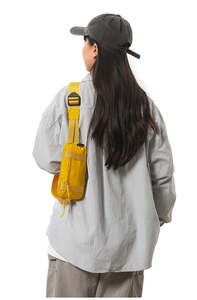 Detail view of bright yellow waterproof sports waist bag with adjustable strap and buckle