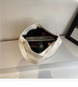Top view of white leather tote bag interior showing spacious storage and magnetic closure