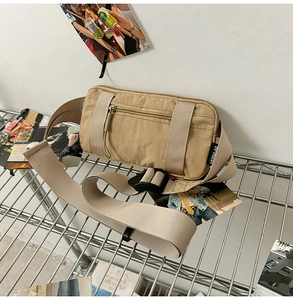 Detail of khaki nylon waist bag featuring high-density water-resistant fabric and buckle