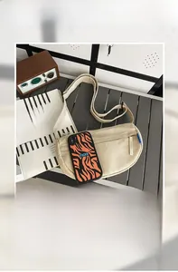 Top view of beige canvas crescent bag interior showing capacity for phone and power bank