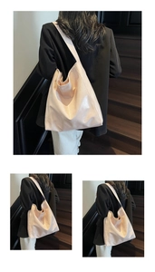 Detail of light pink glossy leather tote bag with wide shoulder strap showing smooth texture