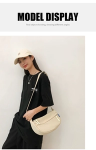 Detail view of beige nylon crescent crossbody bag styled with casual street fashion outfit