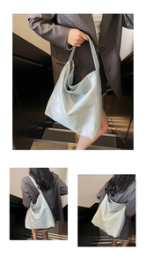 Detailed views of a light blue matte leather tote bag with wide shoulder strap design