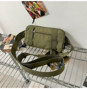 Detail of army green tactical waist bag with durable nylon fabric and reinforced straps