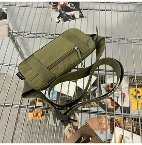 Detail of olive green nylon waist bag with zipper pocket and adjustable buckle strap