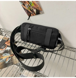 Detail of black nylon sports waist bag with adjustable strap and durable buckle closure