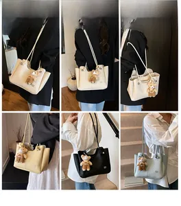 Litchi pattern tote bag with wavy edge, braided straps and cute bear pendant detail