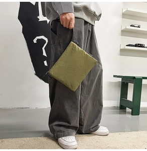 Detail of olive green nylon bag showing the durable texture and plastic side buckle