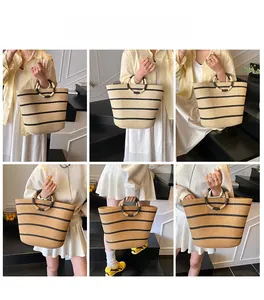 Detail showing natural straw tote texture with black stripes and unique round handle