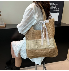 Macro detail of the tricolor woven straw tote bag featuring white lace bow and beads