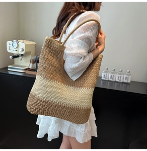 Macro detail of tricolor gradient straw weave pattern and round woven handles on tote bag