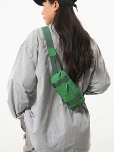 Waterproof green nylon waist bag for sports and cycling worn by a male model