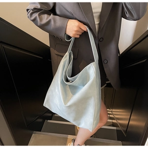 Ice blue hobo tote bag with wide shoulder strap and magnetic closure detail