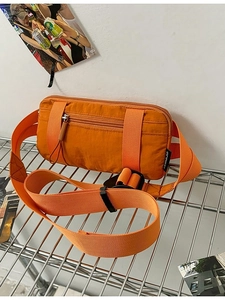 Bright orange nylon crossbody fanny pack with adjustable strap and multiple zipper pockets