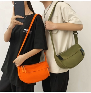 Detail showing orange and olive green nylon crossbody bags with adjustable straps