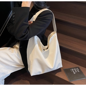 Detail of magnetic buckle and spacious interior of the minimalist beige tote bag