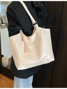Large cream glossy patent leather tote bag with embossed logo and knot detail