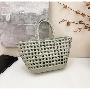 Detail of sage green silicone basket showing thick woven texture and hollow squares