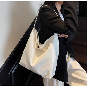 Minimalist white PU leather tote bag shown on model for stylish urban commuting fashion
