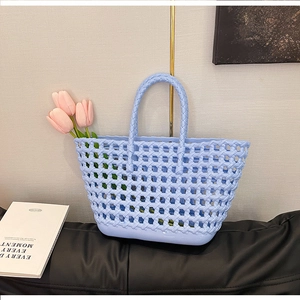 Close-up of light blue hollow-out silicone tote bag with retro woven basket design