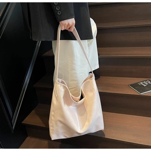 Detail view of a pale pink minimalist tote bag made of soft PU leather for daily commuting