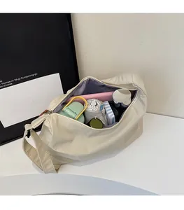 Interior view of large capacity canvas tote bag showing storage for umbrella and notebooks