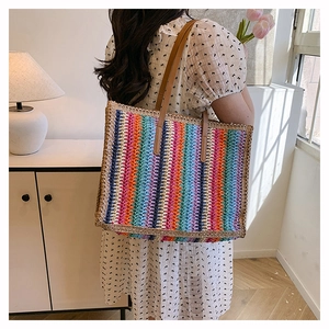 Close-up of vibrant rainbow striped woven tote bag with premium brown leather handles