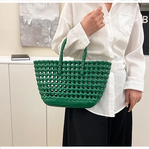 Close-up of green woven jelly bag with glossy PVC texture and durable flat base