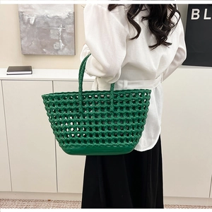 Close-up of vibrant green woven jelly tote bag with glossy hollowed-out basket texture