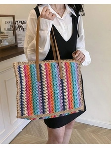Large rainbow striped handmade woven tote bag with brown handles for beach vacation
