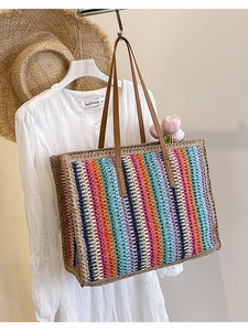 Handmade striped woven straw tote bag with rainbow colors for summer beach vacations