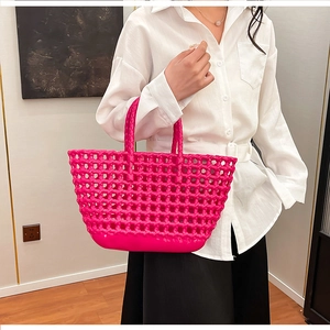 Detail of rose red hollow mesh jelly handbag with woven wide grid design