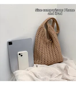 Size comparison of the woven shoulder bag next to an iPhone and iPad for scale