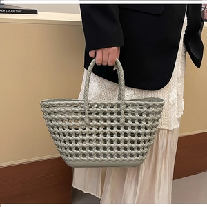 Detail of mint green woven jelly handbag with hollow mesh structure for beach or picnic