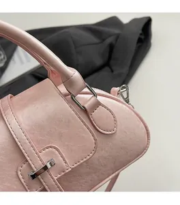 Detail of premium silver-tone hardware and textured pink faux leather on a Boston bag