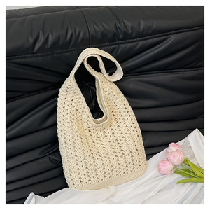 Close-up of cream off-white hand-woven crochet hobo bag with 3D wave knit texture