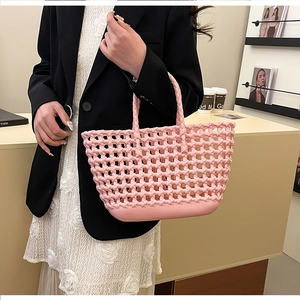 Close-up of pink hollow-out woven jelly bag with thick solid base for picnic and beach