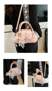 Detailed view of pink shell bag with lace bow pendant and pearl strap decoration