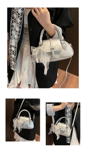 Macro detail of silver textured shell bag with white lace bow and pearl charms