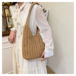 Detail of hand-crocheted hollow knit texture on a beige tote bag for women