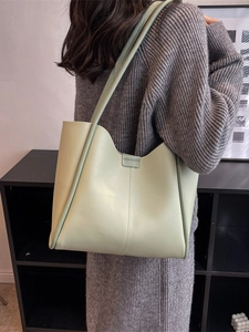 Minimalist mint green faux leather tote bag for women showing large capacity and sleek design