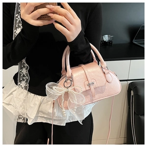 Pink PU leather Boston bag detail featuring delicate lace pearl bow charm and metal buckle