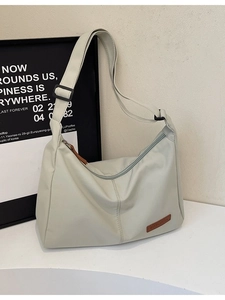 Light grey canvas tote bag with adjustable strap and spacious hobo style for daily commute