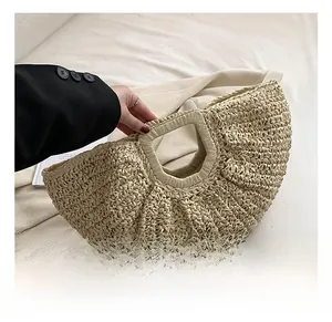 Detail of handmade semi-circular straw bag with woven texture and comfortable handle