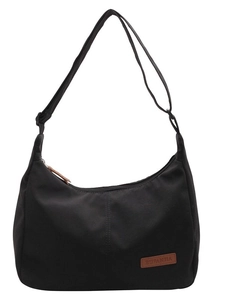 Minimalist black canvas hobo bag with adjustable strap and leather logo detail for women