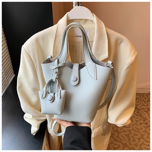 Detail of light blue lychee pattern bucket bag with mini pouch and silver hardware