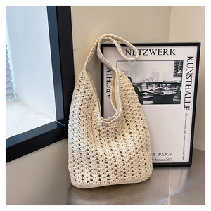 Detailed close-up of ivory crochet tote bag featuring intricate openwork knitting textures