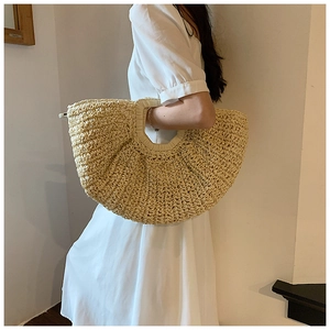 Detail of handwoven straw tote bag with integrated handle for summer beach vacation